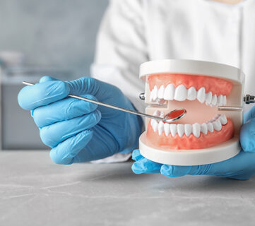 Dentist examining patients teeth using dental tool