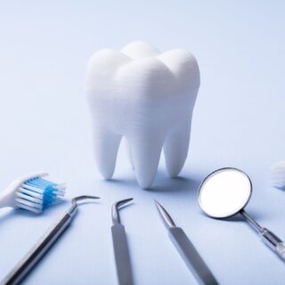 False tooth surrounded by dental tools